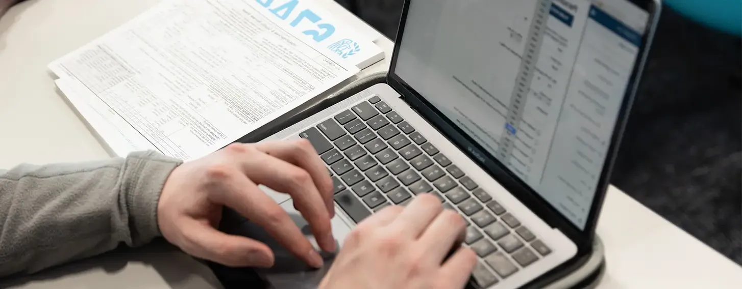 A student working on a laptop computer.